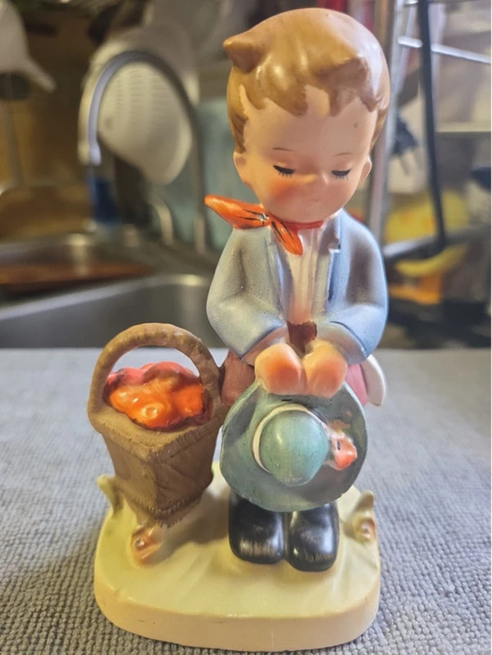 vintage porcelain figurine Of a Hummel-style piece depicting a young boy